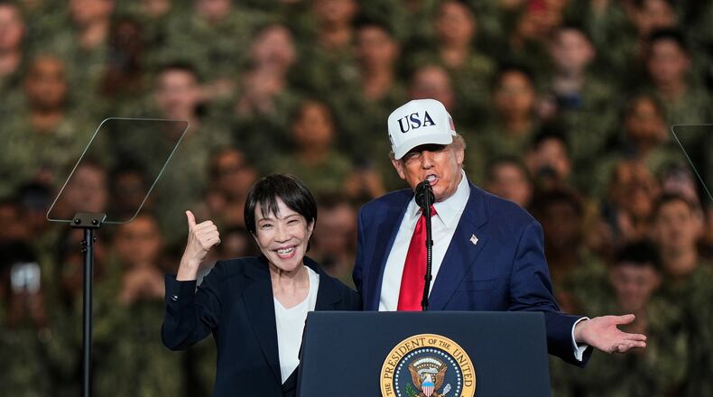 FILE - Japanese Prime Minister Sanae Takaichi gestures as U.S. President Donald Trump delivers his speech during their visit to the aircraft carrier USS George Washington at the U.S. Navy's Yokosuka base in Yokosuka, south of Tokyo, Tuesday, Oct. 28, 2025. (AP Photo/Eugene Hoshiko, File)