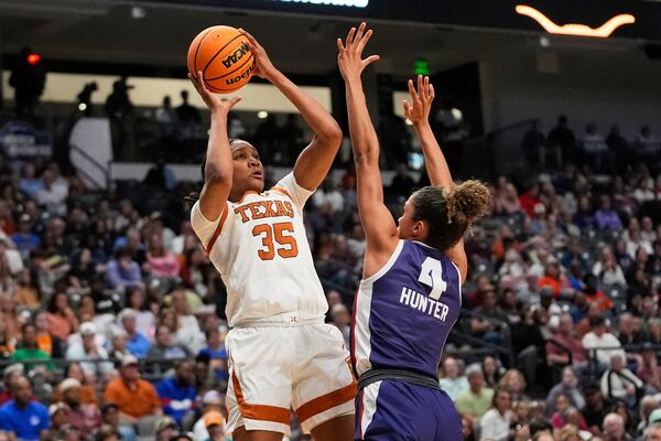 Texas forward Madison Booker (35) shoots against TCU guard Donovyn Hunter (4) during the first half in the Elite Eight of the NCAA college basketball tournament, Monday, March 31, 2025. in Birmingham, Ala. (AP Photo/Gerald Herbert)