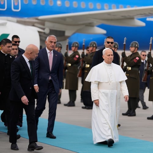 Pope Leo XIV walks as he is welcomed upon his arrival at Esenboga International Airport in Ankara, Turkey, Thursday, Nov. 27, 2025, marking the beginning of his first foreign trip. (AP Photo/Khalil Hamra)