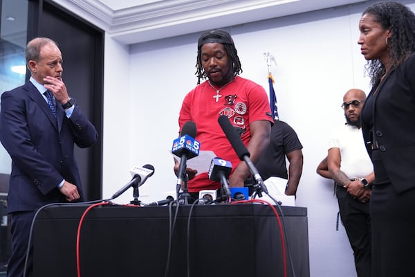One sexual assault survivor Michael Moss, center, talks to media as Jerome Block, partner, Levy & Konigsberg LLP, left, and attorney Kristen Feden listen to him during a news conference in Chicago, Wednesday, July 16, 2025. (AP Photo/Nam Y. Huh)