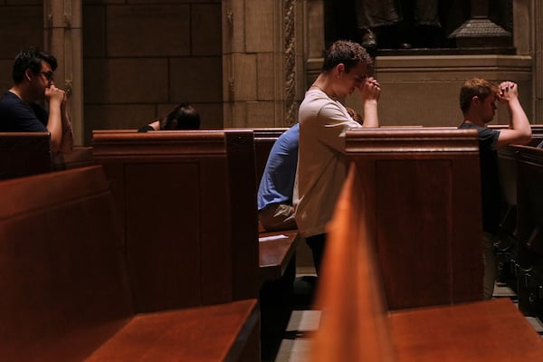 Eric Anderson, center, an associate campus minister at Princeton University prays with others, including Logan Nelson, right, a fellow member of the university’s Catholic campus ministry, after a Mass on Friday, May 16, 2025. (AP Photo/Luis Andres Henao)