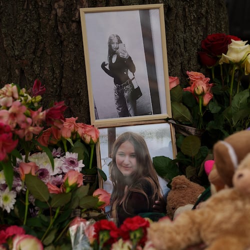 Photos of a girl who was killed are seen among flowers near a heavily damaged house after a Russian strike on a residential neighborhood in Kyiv, Ukraine, Friday, May 15, 2026. (AP Photo/Evgeniy Maloletka)