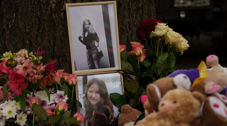 Photos of a girl who was killed are seen among flowers near a heavily damaged house after a Russian strike on a residential neighborhood in Kyiv, Ukraine, Friday, May 15, 2026. (AP Photo/Evgeniy Maloletka)