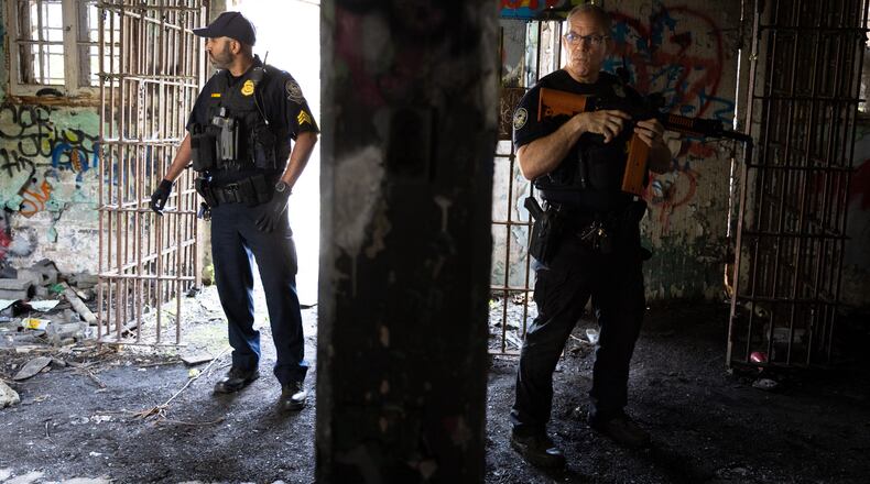 Officers stand in an old prison farm building during an Atlanta Police Department and Atlanta Fire Rescue media tour of the Atlanta Public Safety Training Center site on Friday, May 26, 2023. (Arvin Temkar / arvin.temkar@ajc.com)