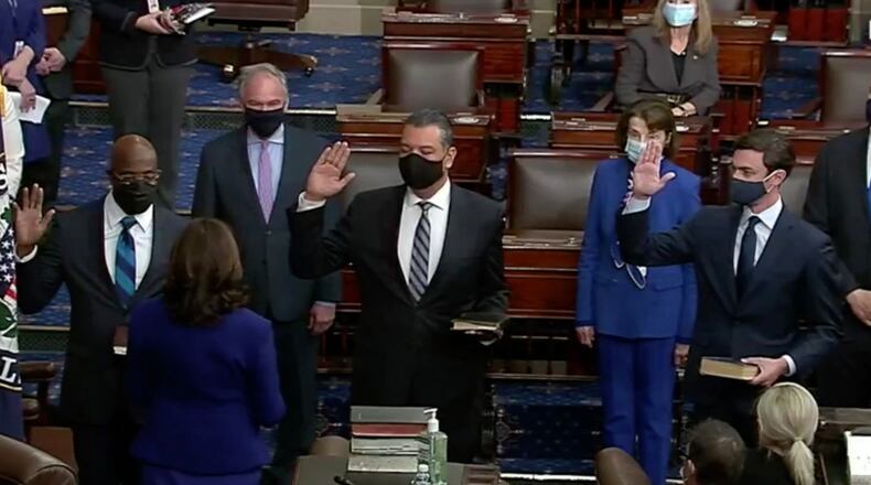 Georgia’s Raphael Warnock, left, and Jon Ossoff, right, are sworn into the Senate along with Alex Padilla of California on Wednesday. (Video image from C-SPAN)