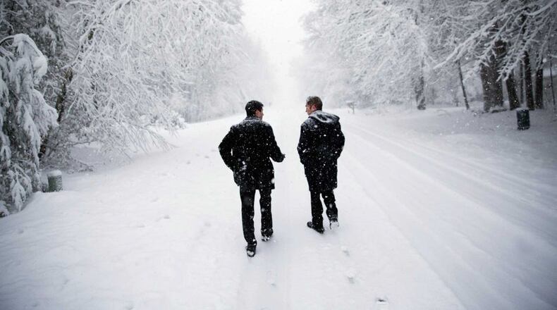 Dave Chiokadze, left, and James Radcliffe, volunteers for Republican presidential candidate Donald Trump, walk through the snow knocking on doors in search of Trump supporters. AP/David Goldman