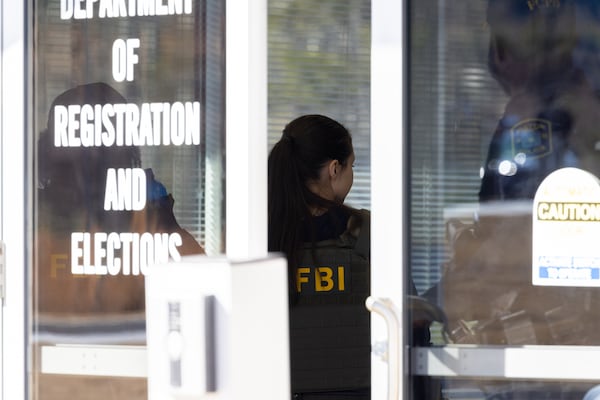 An FBI agent appears in the Fulton County Election Hub and Operation Center in Union City on Wednesday, Jan. 28, 2026. (Arvin Temkar/AJC)