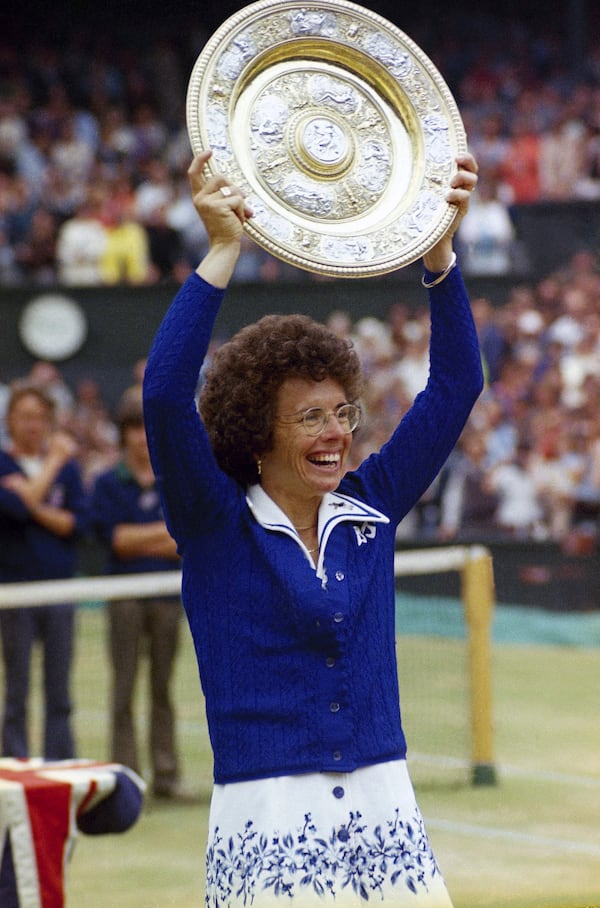 FILE - U.S. tennis star Billie Jean King holds up trophy after winning her sixth singles final at Wimbledon in London, July 4, 1975. (AP Photo,File)