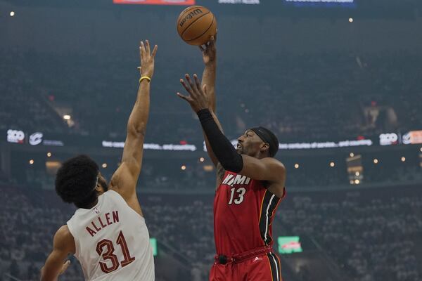 Miami Heat center Bam Adebayo (13) shoots over Cleveland Cavaliers center Jarrett Allen (31) in the first half in Game 1 of an NBA first-round playoff series, Sunday, April 20, 2025, in Cleveland. (AP Photo/Sue Ogrocki)