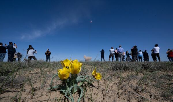 People watch as a Russian Soyuz rocket carrying a Soyuz MS-27 spacecraft with NASA astronaut Jonny Kim and Roscosmos cosmonauts Sergey Ryzhikov and Alexey Zubritsky, makes it's way to the International Space Station from the Russian leased Baikonur cosmodrome, Kazakhstan, Tuesday, April 8, 2025. (Joel Kowsky/NASA via AP)
