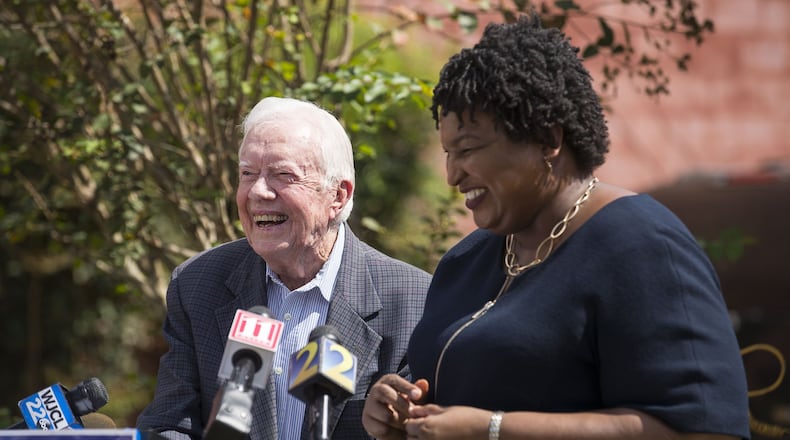 Former President Jimmy Carter and Stacey Abrams, the Democratic candidate to become Georgia’s next governor, share a laugh while taking questions during a press conference Tuesday on rural health care at the Mercer Medicine facility in Plains. (ALYSSA POINTER/ALYSSA.POINTER@AJC.COM)