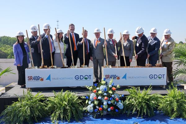 Officials pose during a groundbreaking ceremony in Alpharetta on Wednesday, April 22, 2026. The event marked the official start of construction of roughly 16 miles of express lanes on Ga. 400. (Arvin Temkar/AJC)
