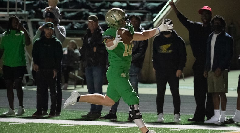 Eli McElwaney celebrates his touchdown for the Buford Wolves during Friday's 39-27 victory over Mill Creek. (Jamie Spaar for the AJC)