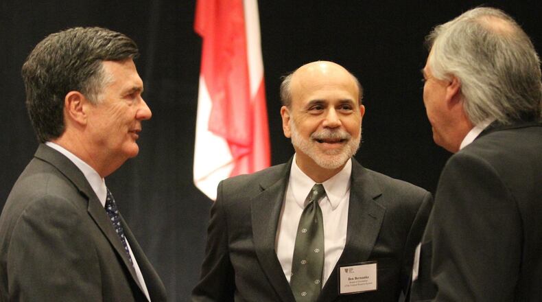 Dennis Lockhart (left), President and CEO of the Federal Reserve Bank of Atlanta, speaks with then-Federal Reserve Chairman Ben Bernanke (center) at a meeting in 2012. HYOSUB SHIN / HSHIN@AJC.COM