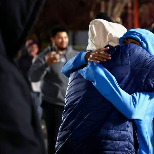 CORRECTS YEAR TO 2026 - People hug each other after a fatal shooting in a parking lot of The Church of Jesus Christ of Latter-day Saints in Salt Lake City on Wednesday, Jan. 7, 2026. (Laura Seitz/The Deseret News via AP)