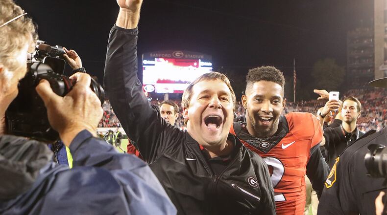 Georgia head coach Kirby Smart and defensive back Maurice Smith, who intercepted a pass and returned it for a touchdown, celebrate a 13-7 victory over Auburn on Saturday, Nov. 12, 2016, in Athens. (Curtis Compton/ccompton@ajc.com)
