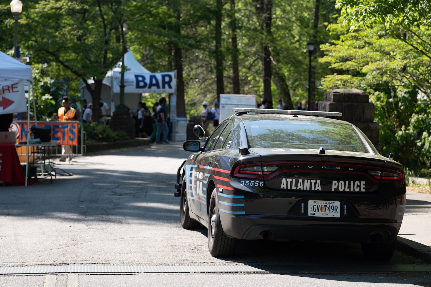 An Atlanta Police car sits at an entrance to Piedmont Park during the Atlanta Dogwood Festival at Piedmont Park on Saturday, April 11, 2026. (Ben Gray for the AJC)