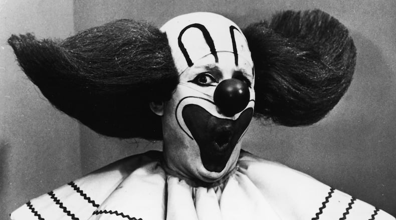 Promotional portrait of Bozo the Clown holding boxes of Bozo Express Bazooka bubble gum with a surprised expression on his face, circa 1965. Frank Avruch, who portrayed the clown, died at age 89. (Photo by Hulton Archive/Getty Images)