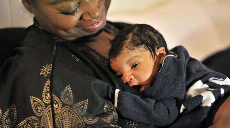 Nikole Pettus bonds with her newborn son Grey at her home. Nikole and her husband Tony welcomed their son after a heartbreaking journey toward parenthood. HYOSUB SHIN / HSHIN@AJC.COM