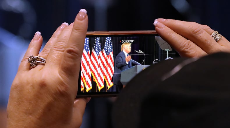 November 8, 2019 Atlanta: A supporter rolls a video on her cell phone while President Donald Trump speaks at the Black Voices for Trump Coalition Rollout on Friday, November 8, 2019, in Atlanta.   Curtis Compton/ccompton@ajc.com