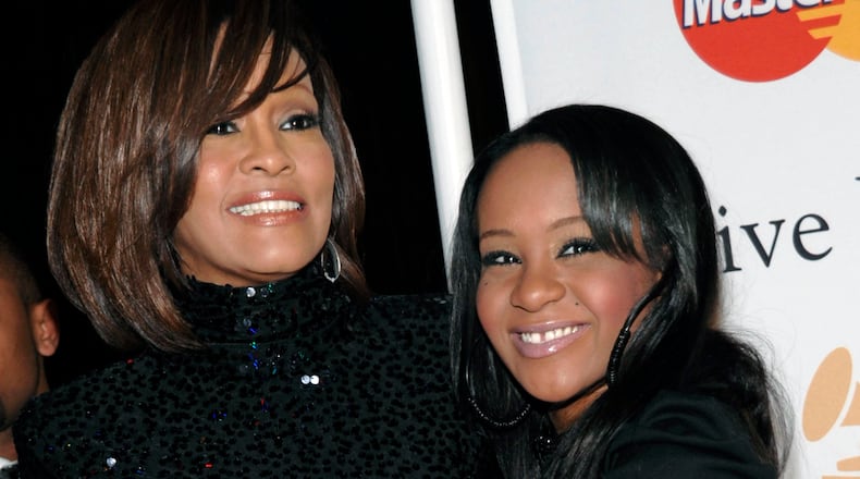The daughter of singer Whitney Houston, Bobbi Kristina Brown, died in July, several months after being found face down in a bathtub at her home in Roswell, Ga. In this Feb. 12, 2011, file photo, Houston, left, and Brown arrive at an event in Beverly Hills, Calif.