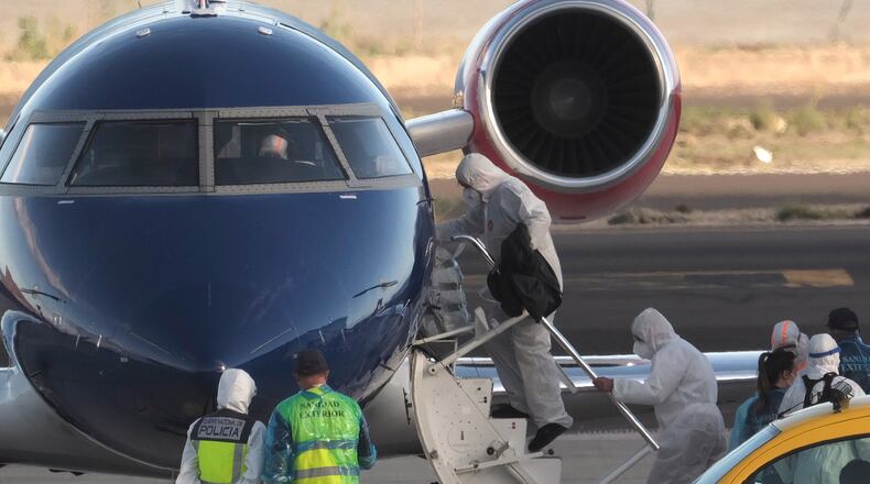 FILE - Passengers board a plane bound for Eindhoven, after disembarking from the hantavirus-stricken cruise ship MV Hondius at the airport in Tenerife, Canary Islands, Spain, Monday, May 11, 2026. (AP Photo/Arturo Rodriguez,File)