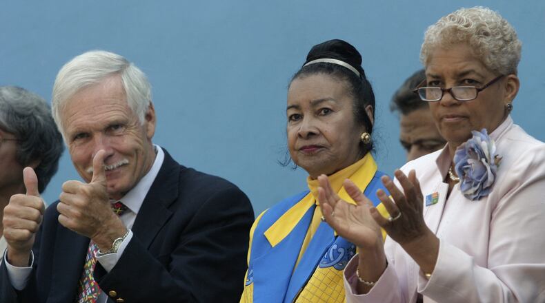 Xernona Clayton (center) is applauded by Ted Turner (left), Mayor Shirley Franklin (right) and attendees to the International Civil Rights Walk of Fame event at the Martin Luther King, Jr. National Historic Site on Aug. 26, 2005. Clayton is the creator of the Walk of Fame, a display of footprints of "foot soldiers" for human rights.