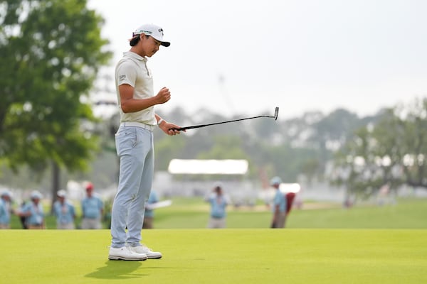 Min Woo Lee, of Australia, reacts after a putt on the 18th green to win the Houston Open golf tournament in Houston, Sunday, March 30, 2025. (AP Photo/Ashley Landis)