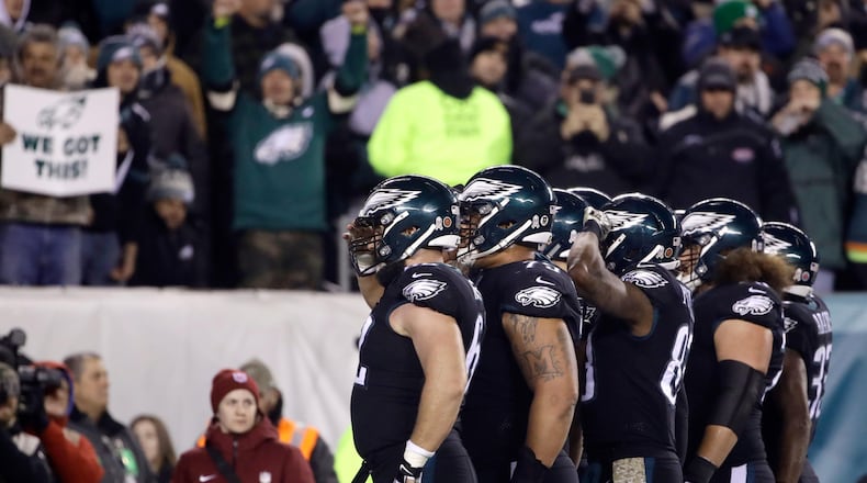 Philadelphia Eagles players salute as they celebrate a touchdown pass from quarterback Carson Wentz to tight end Zach Ertz late in the third quarter against the Dallas Cowboys.