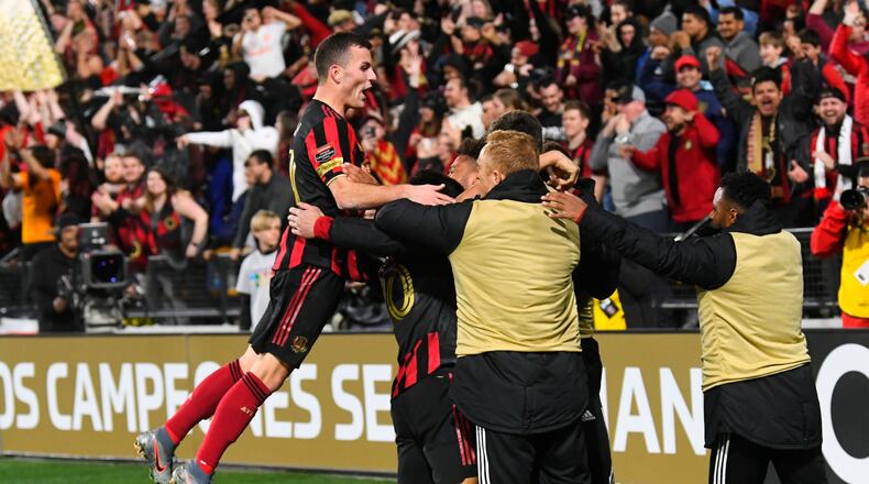 Atlanta United defender Brooks Lennon leaps to join the celebration of a goal by Gonzalo Martinez during the second half of a soccer match against Motagua FC in the Scotiabank Concacaf Champions League, Tuesday, Feb. 25, 2020, in Kennesaw, Ga. Atlanta United won 3-0. (John Amis, Atlanta Journal Constitution)