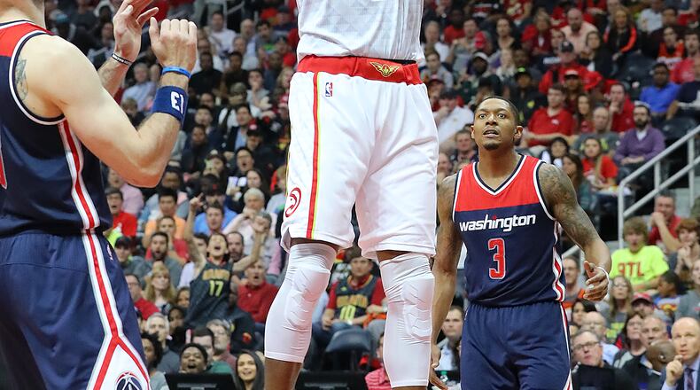 Dwight Howard of the Hawks dunks for two over Marcin Gortat and Bradley Beal of the Wizards in Game 4 of a first-round playoff series on Monday, April 24, 2017, in Atlanta. Curtis Compton/ccompton@ajc.com