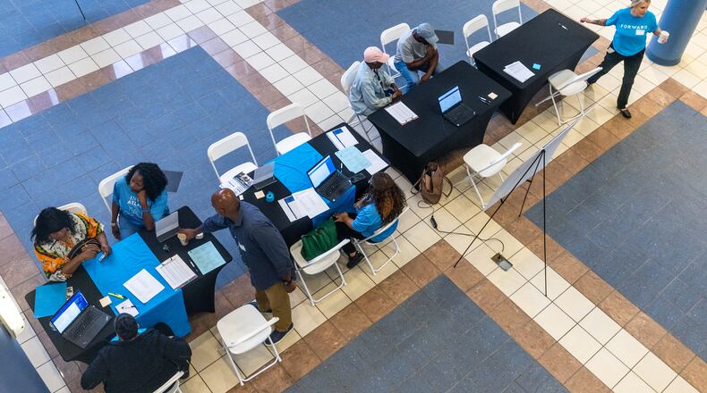Volunteers help participants during the application assistance session at Atlanta Metro State College on Tuesday, Aug 6, 2024, apply for the anti-displacement tax relief fund program. (Steve Schaefer / AJC)