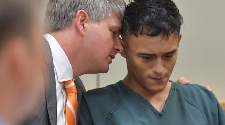 Lawrenceville - Francisco Palencia, 17, and his attorney Scott Smith confer during a hearing in Gwinnett County Magistrate Court at Gwinnett County Detention Center on Friday, July 14, 2017. Josue Ramirez, 19, Francisco Palencia, 17, and Angela Garcia, 18, have been charged with home invasion, rape, aggravated sodomy, kidnapping, aggravated battery and cruelty to children in connection with a May assault. HYOSUB SHIN / HSHIN@AJC.COM