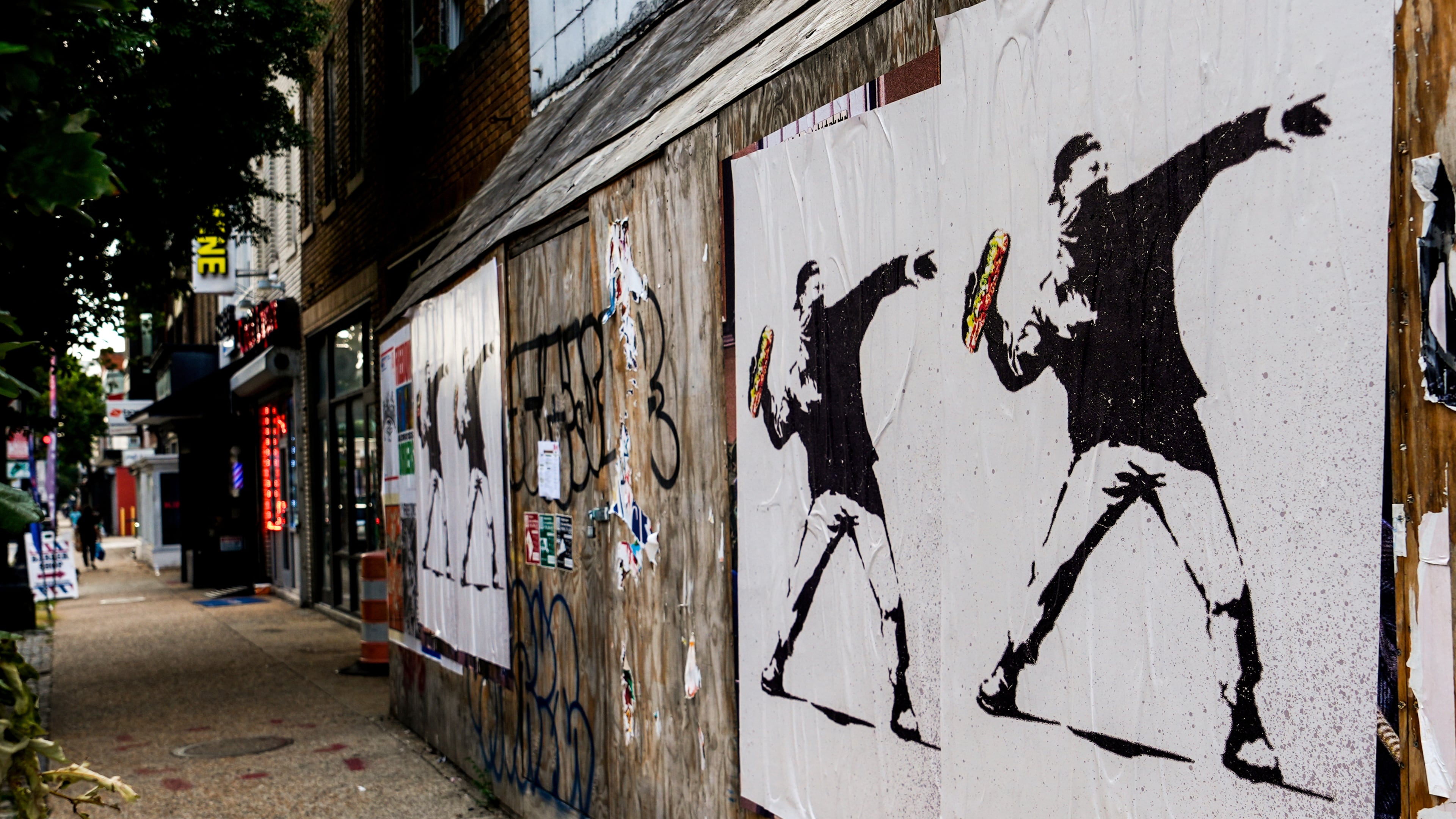 FILE - Posters of a person throwing a sandwich are pictured along H Street, Aug. 17, 2025, in Washington. (AP Photo/Julia Demaree Nikhinson, File)