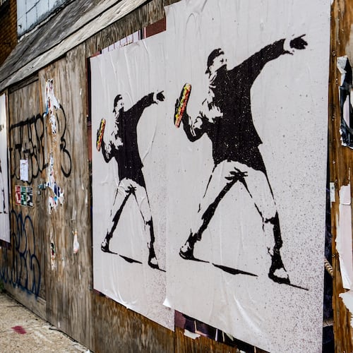 FILE - Posters of a person throwing a sandwich are pictured along H Street, Aug. 17, 2025, in Washington. (AP Photo/Julia Demaree Nikhinson, File)