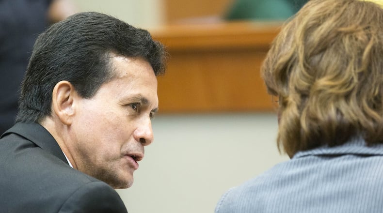 Dr. José Rios speaks with one of his defense attorneys, Laila Kelly, during his sexual battery trial on Thursday. On Friday, a DeKalb County jury aquitted him of both counts. ALYSSA POINTER/ALYSSA.POINTER@AJC.COM