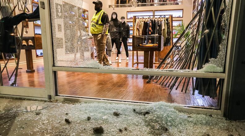 Shattered glass litters the sidewalk outside A Ma Maniere on Marietta Street after the second smash-and-grab burglary in three months. JOHN SPINK/JSPINK@AJC.COM