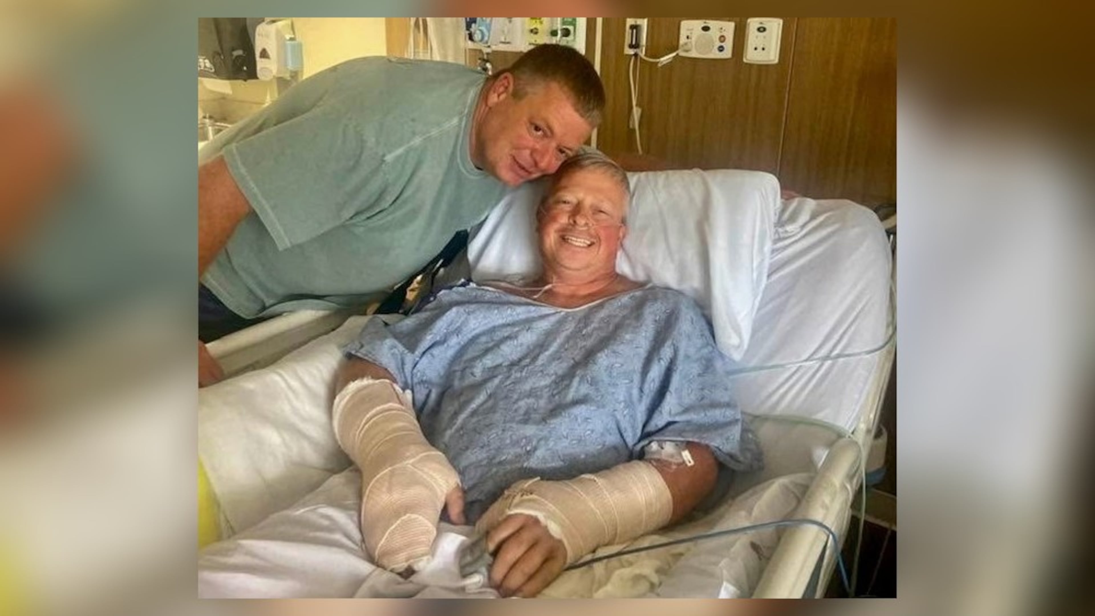 Police officer Jay Hood visits his friend Chad Wombles, a Wrightsville firefighter, in the hospital days after Wombles was attacked by a man with a sword. Doctors have reattached Wombles' hand. (Courtesy photo)