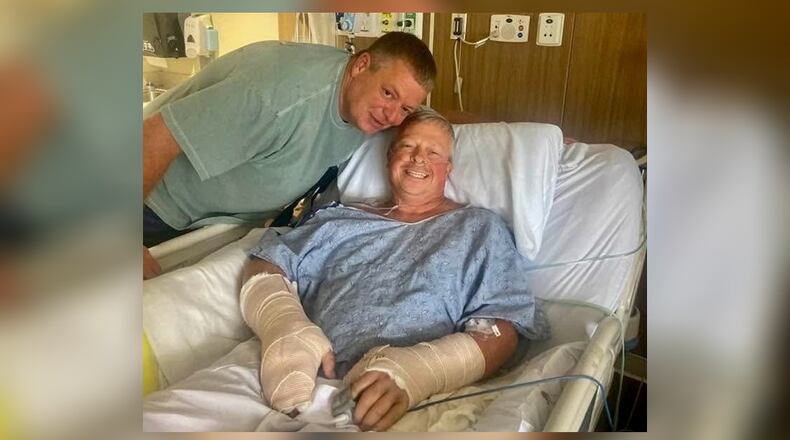 Police officer Jay Hood visits his friend Chad Wombles, a Wrightsville firefighter, in the hospital days after Wombles was attacked by a man with a sword. Doctors have reattached Wombles' hand. (Courtesy photo)