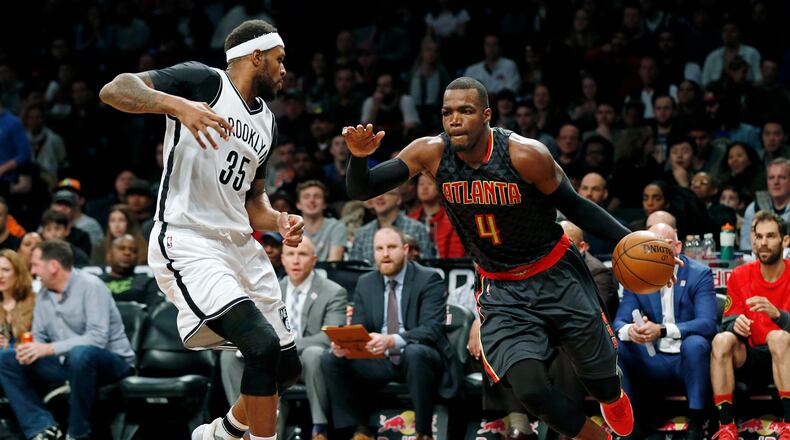 Atlanta Hawks forward Paul Millsap (4) drives to the basket past Brooklyn Nets forward Trevor Booker (35) during the second half of an NBA basketball game Sunday, April 2, 2017, in New York. The Nets won 91-82. (AP Photo/Adam Hunger)
