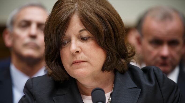 In this photo taken Tuesday, Sept. 30, 2014, Secret Service Director Julia Pierson appears before the House Oversight Committee as it examines details surrounding a security breach at the White House when a man climbed over a fence, sprinted across the north lawn and dash deep into the executive mansion before finally being subdued, on Capitol Hill in Washington. Pierson, a 30 year veteran of the Secret Service, resigned Wednesday, Oct. 1, 2014, amid intense scrutiny and revelations of several security lapses. (AP Photo/J. Scott Applewhite) Julia Pierson testifies before Congress on Tuesday, before resigning as director of the Secret Service. (AP Photo/J. Scott Applewhite)