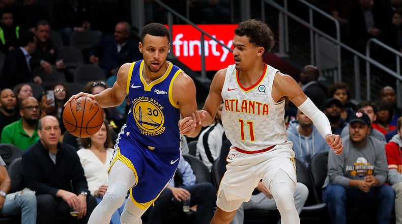 Stephen Curry of the Golden State Warriors drives against Trae Young of the Atlanta Hawks (Photo by Kevin C. Cox/Getty Images)
