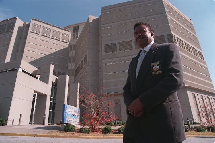DeKalb Sheriff Sidney Dorsey standing in front of the DeKalb County Jail on Memorial Drive, Dec. 4, 1998. (Renee' Hannans/AJC file photo)