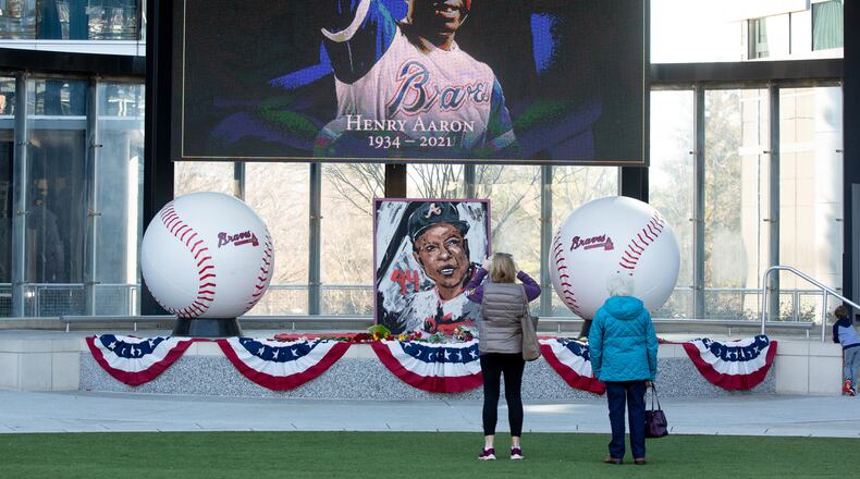 Karen Kasprowicz (left) and her mother, June Chandler, take a photograph of the Hank Aaron memorial at Truist Park on Saturday, January 23, 2021, a day after the baseball legend died. (Photo: Steve Schaefer for The Atlanta Journal-Constitution)