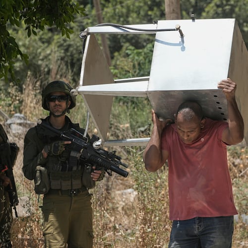 Palestinians collect their belongings from their evacuated homes after the Israeli army issued a number of short term access permits for residents of the occupied West Bank refugee camp of Tulkarem, Wednesday, June 17, 2026. (AP Photo/Majdi Mohammed)