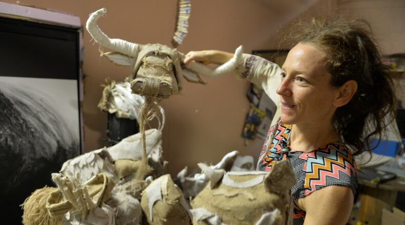 Choreographer Lauri Stallings shows off some of the handmade animal masks that dancers wore during part of their performance of “Cloth(Field)” at the Goat Farm in Atlanta. Stallings has just won the Hudgens Prize. Photo: BRANT SANDERLIN