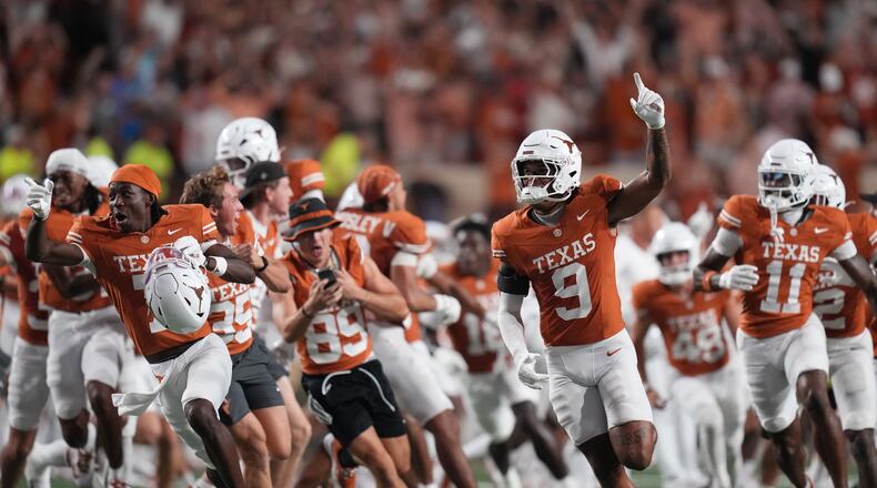 Texas players celebrate their win over Ohio State in an NCAA college football game in Austin, Texas, Saturday, Sept. 12, 2026. (AP Photo/Eric Gay)