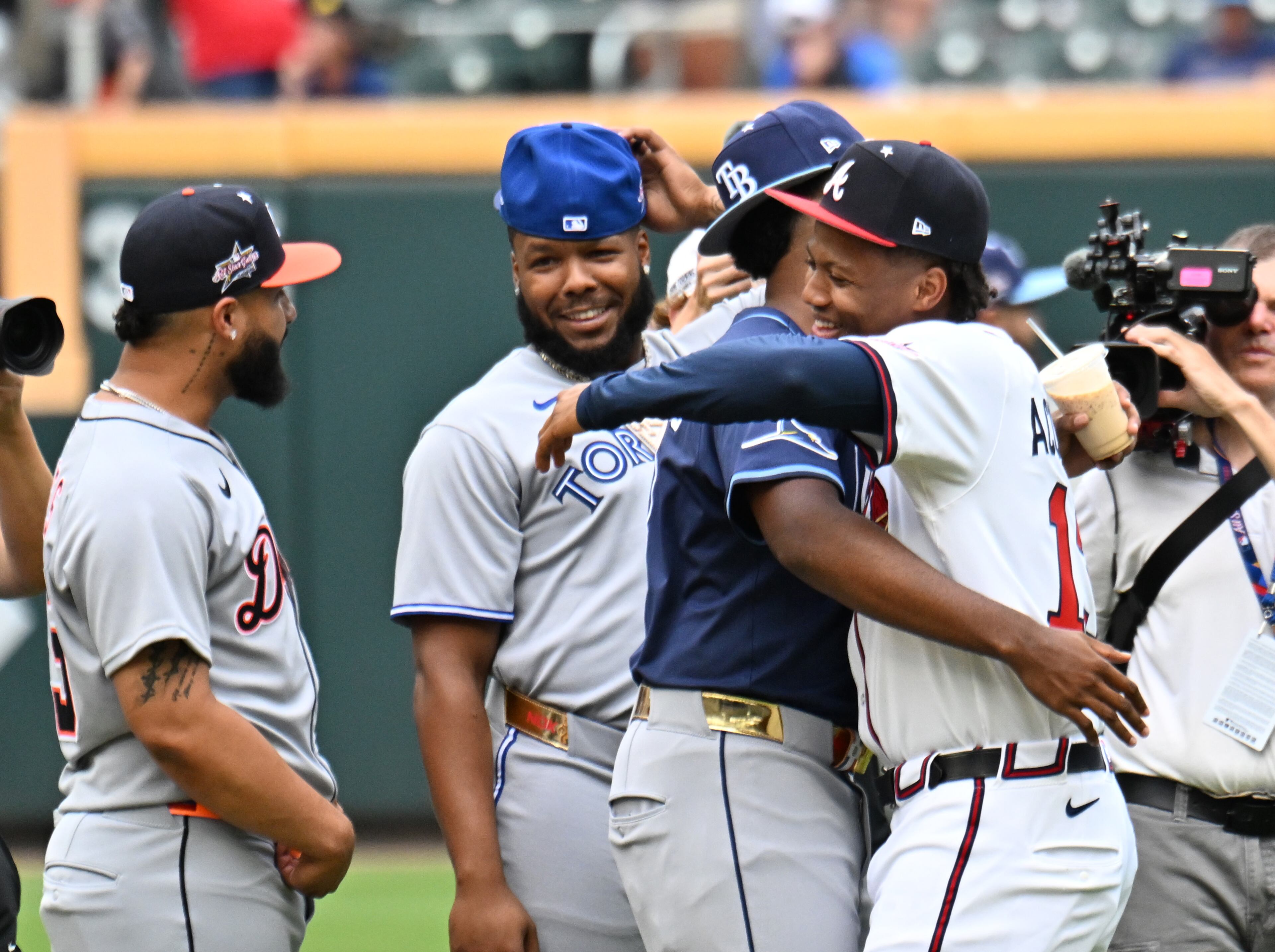 Atlanta Braves outfielder Ronald Acuña Jr. (right) hugs Tampa Bay Rays infielder Junior Caminero before the 2025 MLB All-Star Game at Truist Park, Tuesday, July 15, 2025, in Atlanta. (Hyosub Shin/AJC)