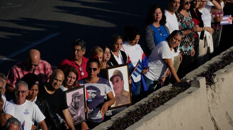 People line the streets of Havana, Cuba, Thursday, Jan. 15, 2026, to watch the motorcade carrying urns containing the remains of Cuban officers killed during the U.S. operation in Venezuela that captured Venezuelan President Nicolas Maduro. (AP Photo/Ramon Espinosa)