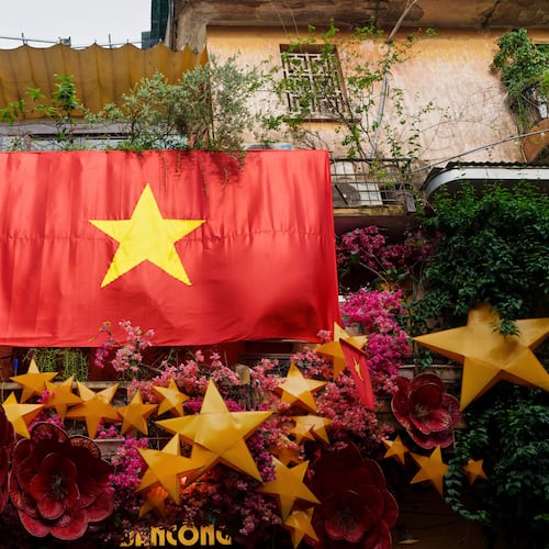 FILE - A giant Vietnamese national flag hangs from a balcony in the old quarter of Hanoi, Vietnam, Monday, Sept. 1, 2025. (AP Photo/Vincent Thian, File)